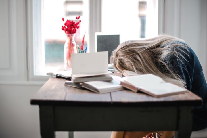 Woman with her head on the desk
