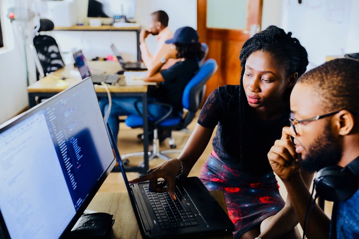 Work colleagues looking at a computer monitor