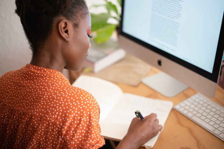 Woman writing at her desk