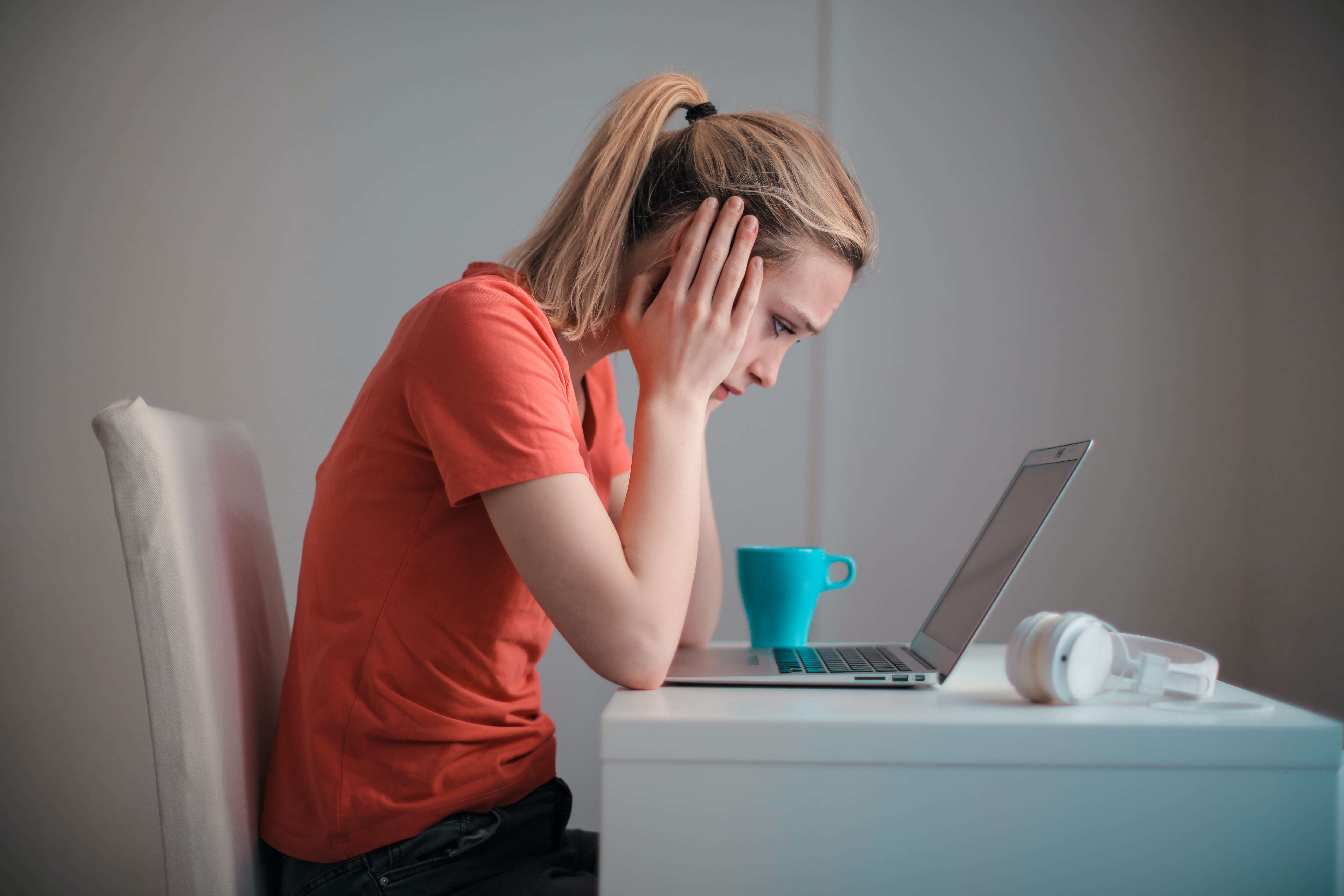 Woman sitting at her computer receiving bad news